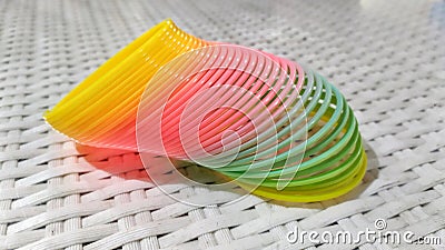 rainbow colored spiral toys on the table Stock Photo