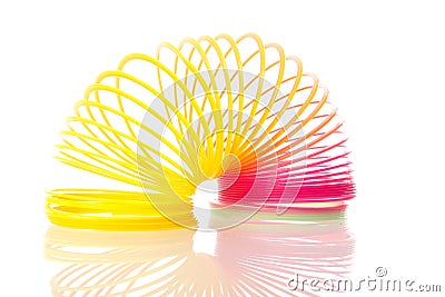 Rainbow colored wire spiral toy on white background Editorial Stock Photo