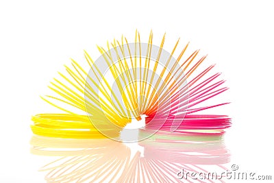 Rainbow colored wire spiral toy on white background Editorial Stock Photo