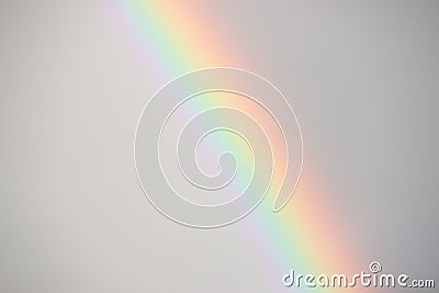 Curve of a brilliant rainbow against a dark sky. Stock Photo