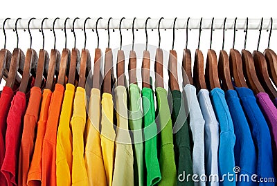 Rainbow colors, clothes on wooden hangers Stock Photo