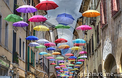 hundreds of colorful umbrellas hanging from the wire Editorial Stock Photo