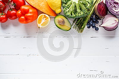 Rainbow colors vegetables and berries on white background, top view. Detox, vegan food, ingredients for juice and salad Stock Photo