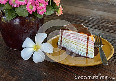 Rainbow crepe cake and chocolate on top. Stock Photo