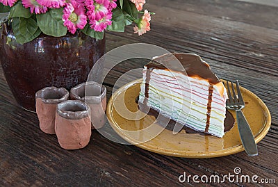 Rainbow crepe cake and chocolate on top. Stock Photo