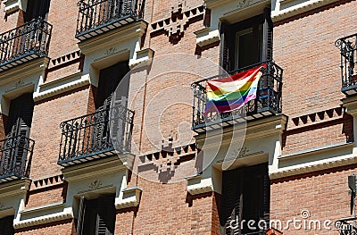 Rainbow flag of gay community on the balcony of classical building downtown Madrid, Spain Stock Photo