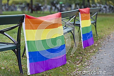 Rainbow Flags hanging on benches Stock Photo