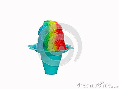 Rainbow Hawaiian Shave ice, Shaved ice or snow cone in a blue flower shaped cup against a white background. Stock Photo