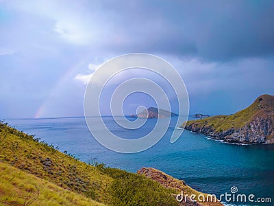 a rainbow in the middle of a sea that is so beautiful, the sea is the most comfortable place to unwind Stock Photo