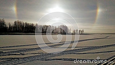 Rainbow nod covered with ice and snow lake with traces of sledges Stock Photo