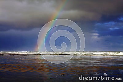 Rainbow and Dramatic Storm Clouds at Nye Beach, Newport, Oregon Coast Stock Photo