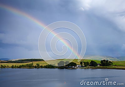 Rainbow over a lake Stock Photo