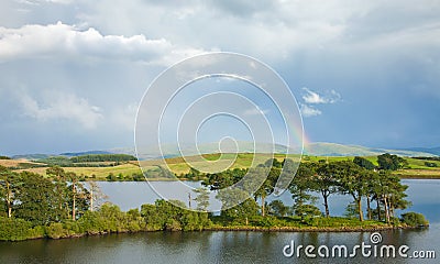 Rainbow over a lake Stock Photo