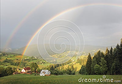 Rainbow over the mountains Stock Photo