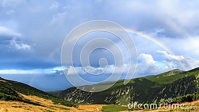 Rainbow over mountains Stock Photo