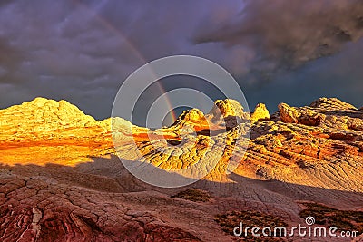 Rainbow over the Plateau White Pocket during sunset Stock Photo