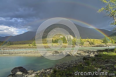 Rainbow over the river. Altai Mountains, Russia. Stock Photo