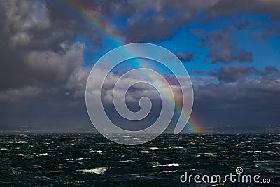 Rainbow Over Rough Seas In The English Channel Stock Photo