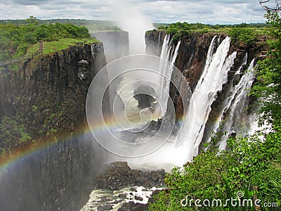 Rainbow over Victoria Falls on Zambezi River Stock Photo