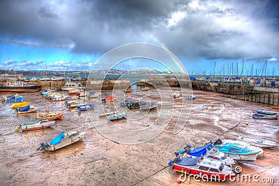 Rainbow at Paignton harbour Devon England uk in colourful HDR with boats and view to Torquay Editorial Stock Photo