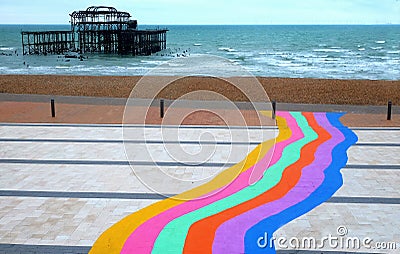 Rainbow pathway and Brighton west pier Stock Photo