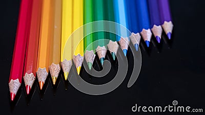 Rainbow pencil colors on a black glass Stock Photo