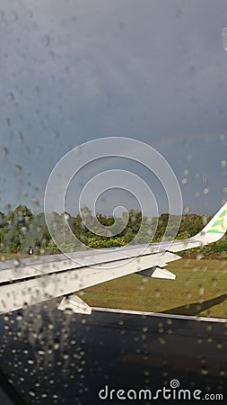 Rainbow rain plane window Stock Photo