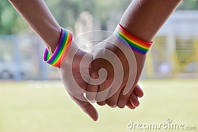 Rainbow rubber wristbands in wrists of asian boy couple Stock Photo