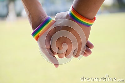 Rainbow rubber wristbands in wrists of asian boy couple Stock Photo