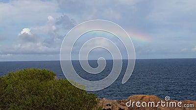 Rainbow on the Sea Horizon Stock Photo