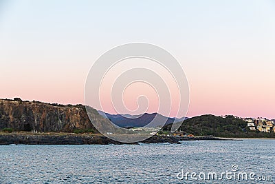 Rainbow skies by the ocean Stock Photo