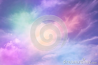 Rainbow sky with fluffy clouds. Abstract purple green yellow background with space for design. Multicolored toned sky. Stock Photo