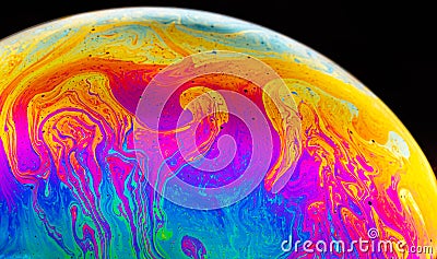 Rainbow soap bubble on a dark background. Close-up of colorful surface Stock Photo