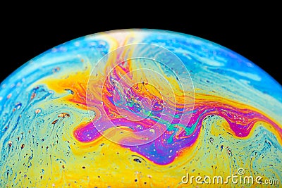 Rainbow soap bubble on an isolated black background. Close-up of the colorful surface. Poster blank Stock Photo