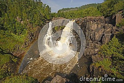 Rainbow by Spectacular Falls in the Summer Stock Photo