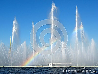 Rainbow in the streams of a fountain on a river Stock Photo