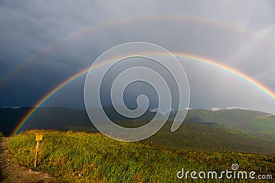 Rainbow at the summit of Mont Ernest Laforce Stock Photo