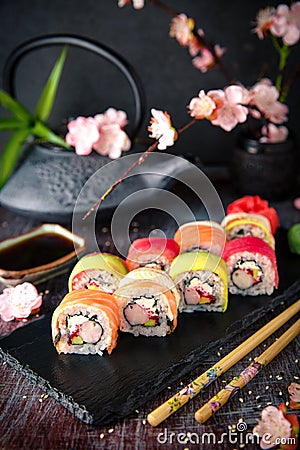 Rainbow Sushi Roll with salmon, eel, tuna, avocado, royal prawn, cream cheese Philadelphia, caviar tobica, chuka. Sushi menu. Stock Photo