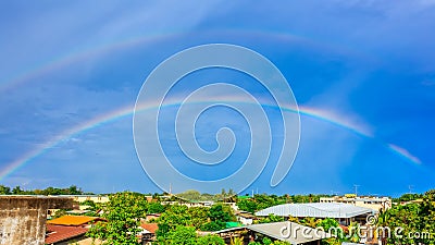 Rainbows on blue sky over the roof top Stock Photo