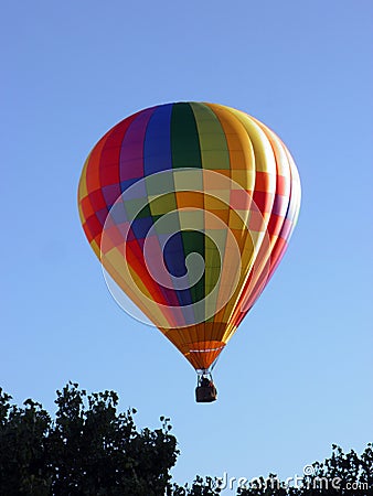 Eye catching rainbow balloon glowing in the skies at the Albuquerque International Balloon Fiesta Stock Photo