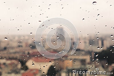 Raindrops on the dirty glass, behind the glass blurred panorama Stock Photo