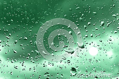 Raindrops on glass for green backdrop rainy fall autumn weather. Abstract backgrounds with rain drops on window Stock Photo