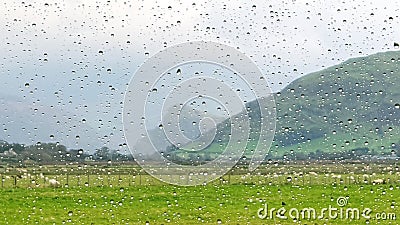 Raindrops rain drops on window with cloudy and rural landscape background Stock Photo