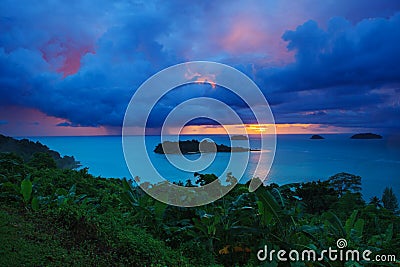 Raining clouds and sun set sky behind koh chang island in trat p Stock Photo