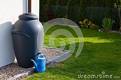 Rainwater barrel downspout modern design house exterior Stock Photo