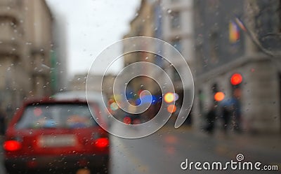 Rainy city scenery through wet windscreen Stock Photo