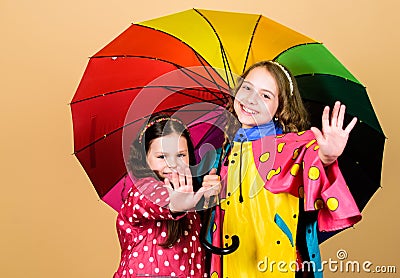 Rainy day fun. Happy walk under umbrella. Kids girls happy friends under umbrella. Rainy weather with proper garments Stock Photo