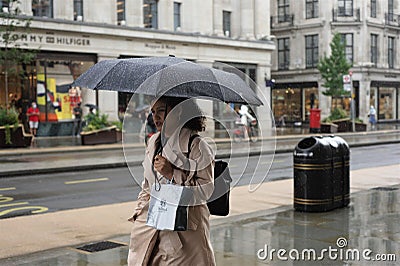 Rainy day in London city centre with people and umbrellas, England 2021 Editorial Stock Photo