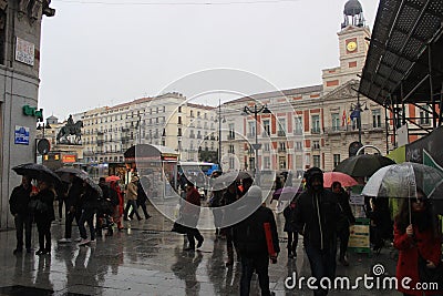 Rainy day in Madrid, capital of Spain. Walking street with pedestrians. rain umbrella Editorial Stock Photo