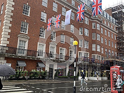 Rainy day in Mayfair in London with coronation flags and British flags in May 2023 Editorial Stock Photo